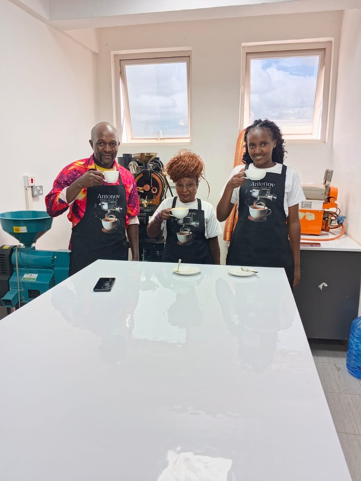 Antonov students and an instructor tasting coffee together