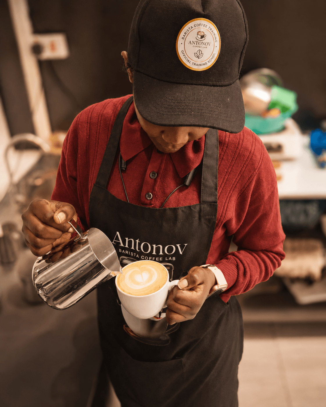 Barista pouring latte art at Antonov Coffee Lab